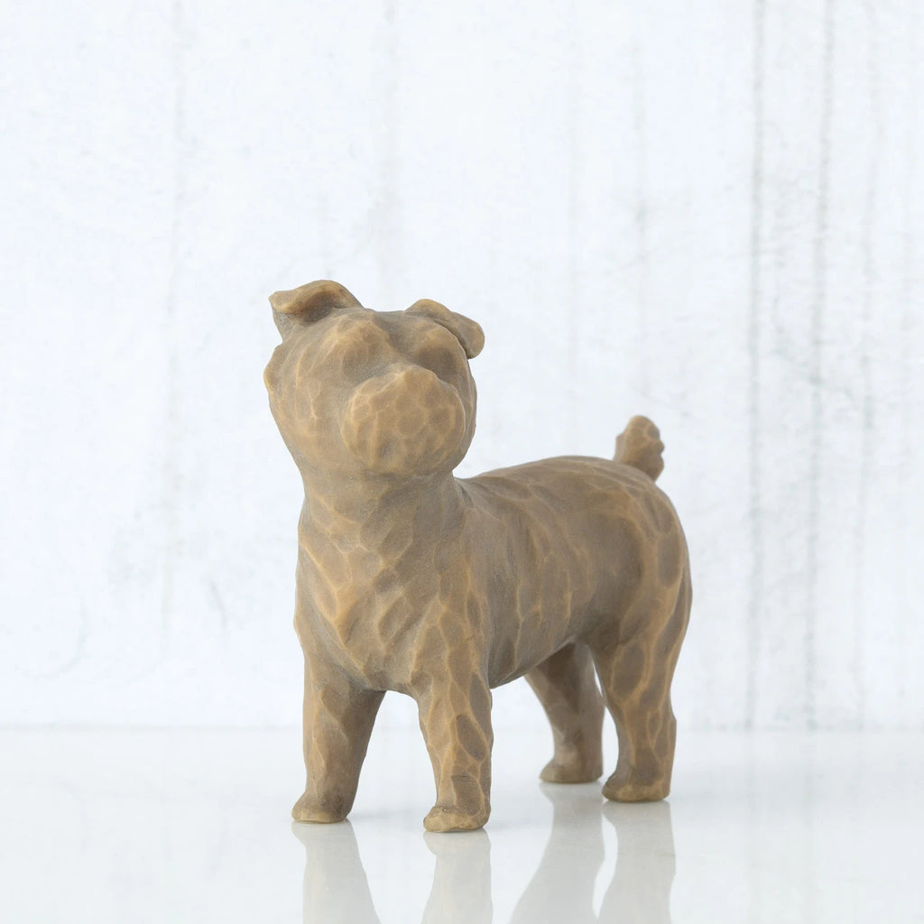Small golden/grey dog figurine standing up