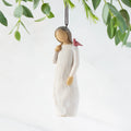 Front view of figure in cream dress with cardinal red bird perched on shoulder, hook & loop in head