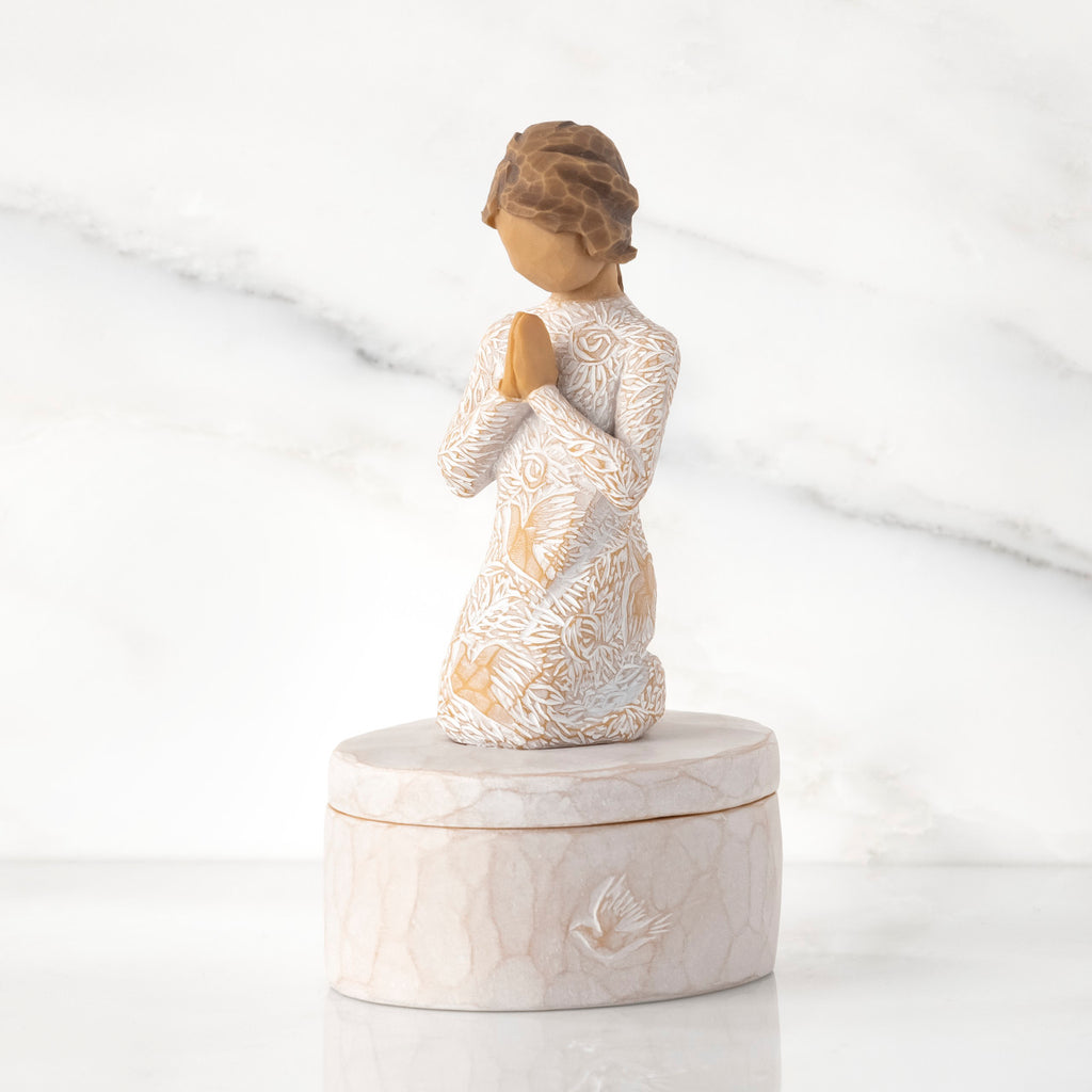 Cream oval resin box, 3-D figure in prayer pose atop lid, in cream dress carved with birds and flowers