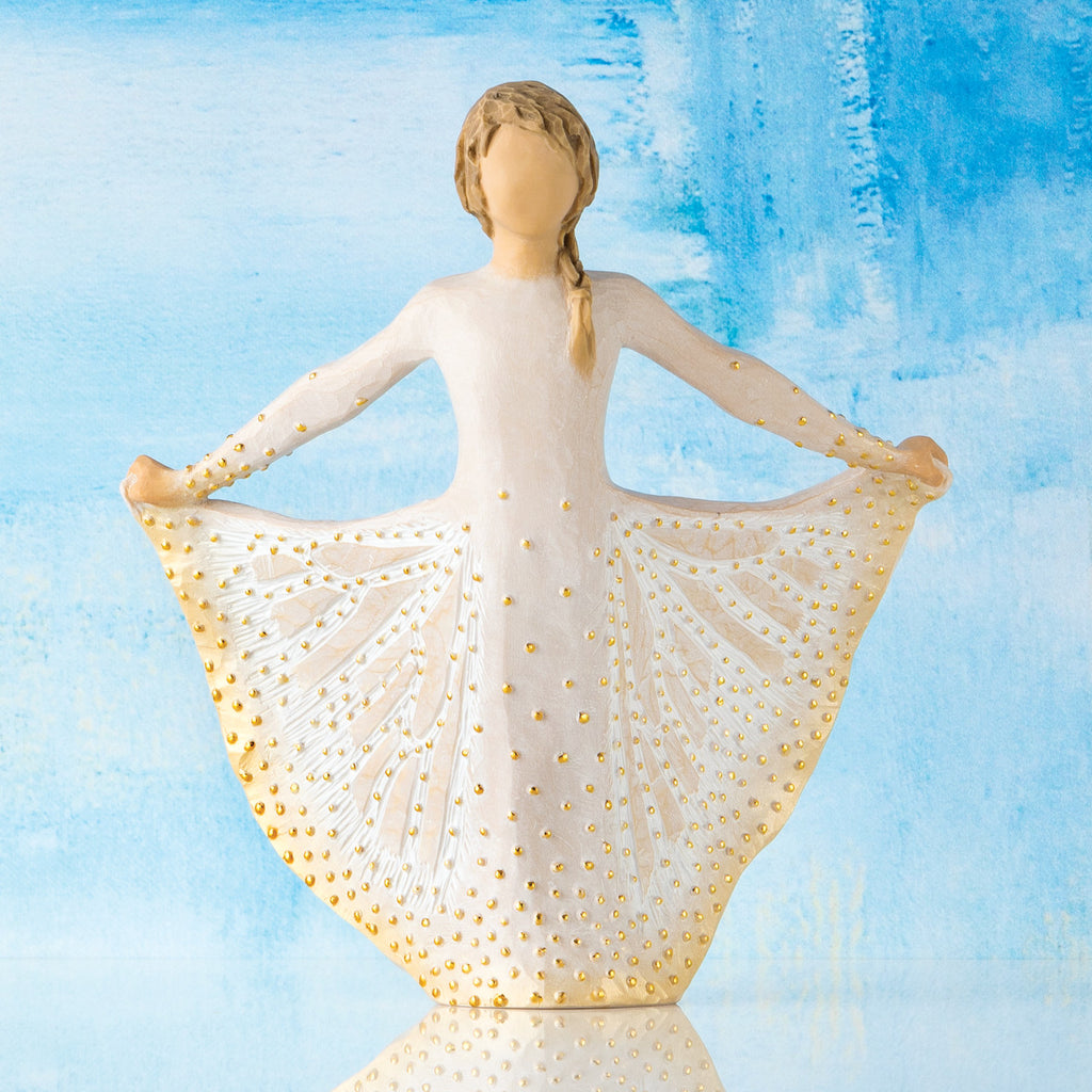 Willow Tree Butterfly, 6.5”h hand-painted standing resin figure in cream dress, holding sides of skirt out with hands, skirt has carved markings of a monarch butterfly with gold leaf, in front of sky blue painting
