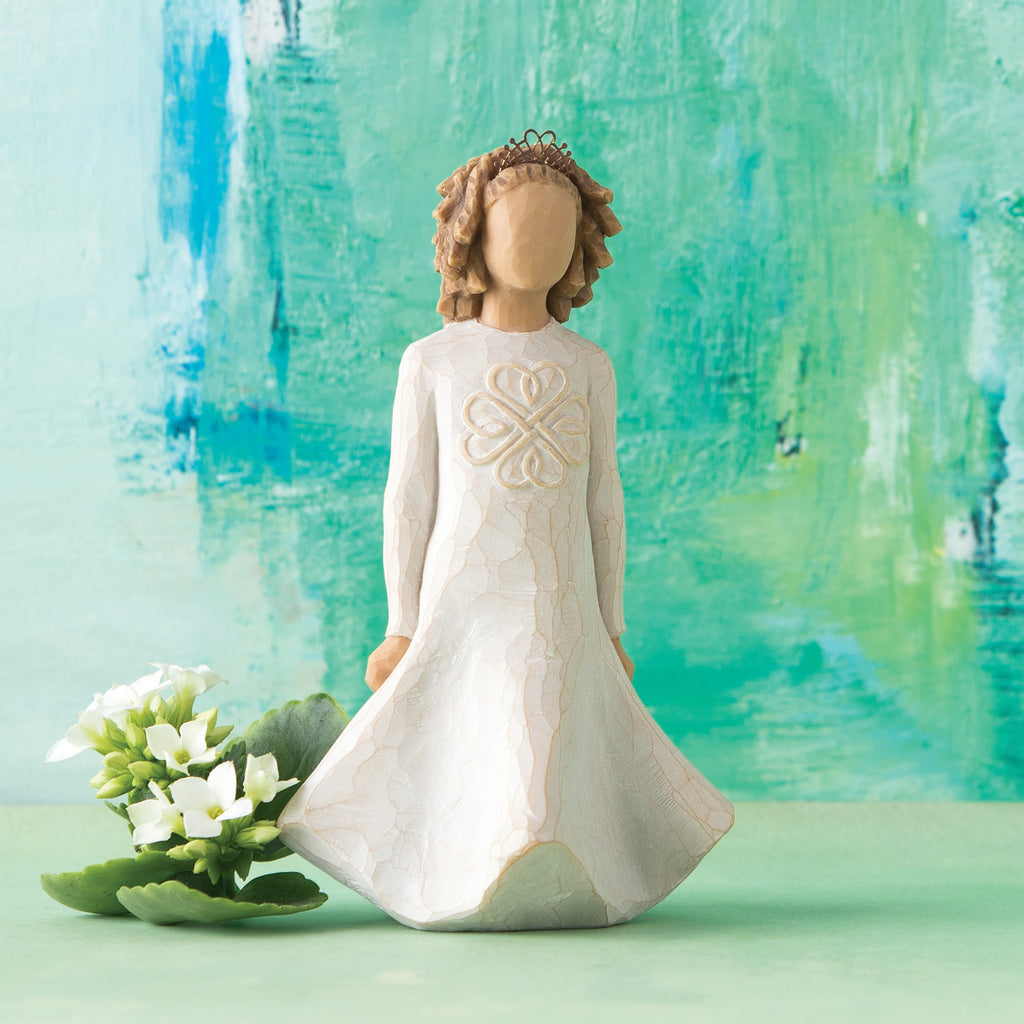 Willow Tree Irish Charm, 5.5" hand-painted dancing resin figure in cream dress with full skirt carved with stylized Celtic knot, arms down to sides, wire crown of hearts, in front of blue-green painting