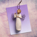 Willow Tree Just for You Ornament, 4”h hand-painted resin angel ornament in cream dress with wire wings, holding wire circle with 'thank you' written in wire, laying on lavender painting