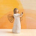 Willow Tree Angel of Hope, 5.5"h hand-painted standing resin figure in cream dress with wire wings, holding candle with gold-leaf flame in hands, in front of orange painting
