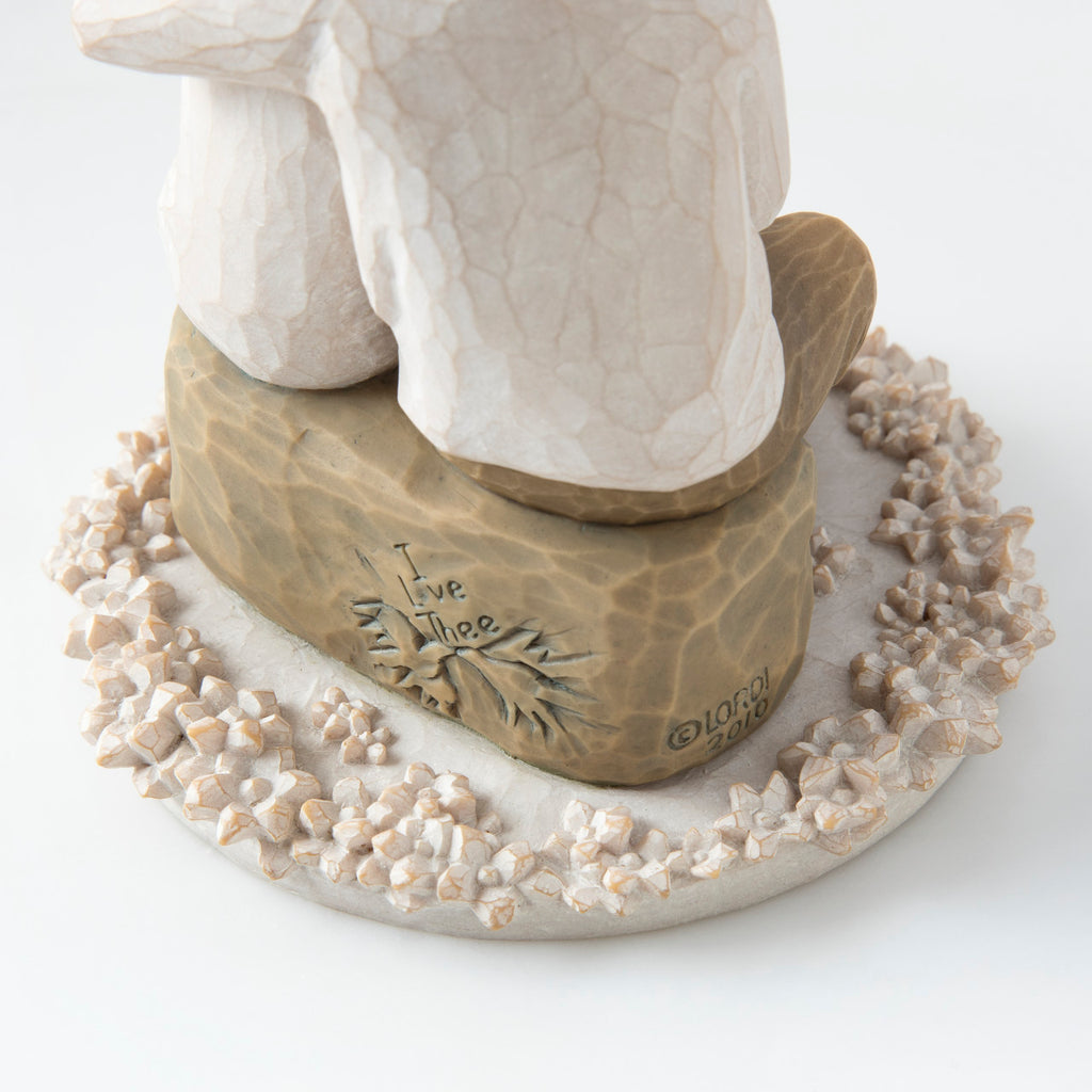Close view of round white plaque with golden rock on top