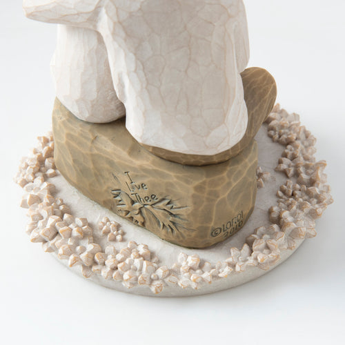 Close view of round white plaque with golden rock on top