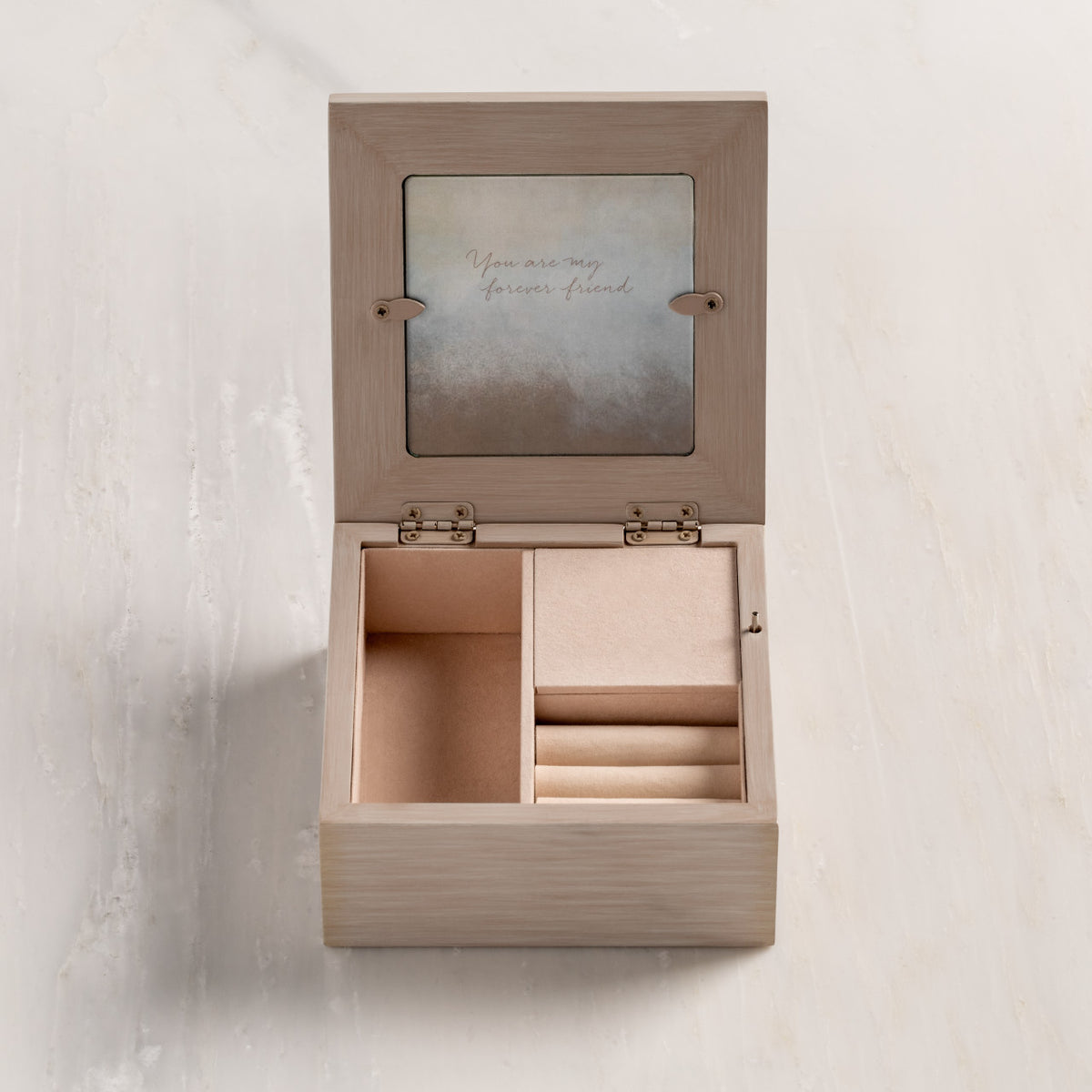 Inside view of cream wood box with open hinged lid with photo frame, showing blush fabric lining and jewelry insert.