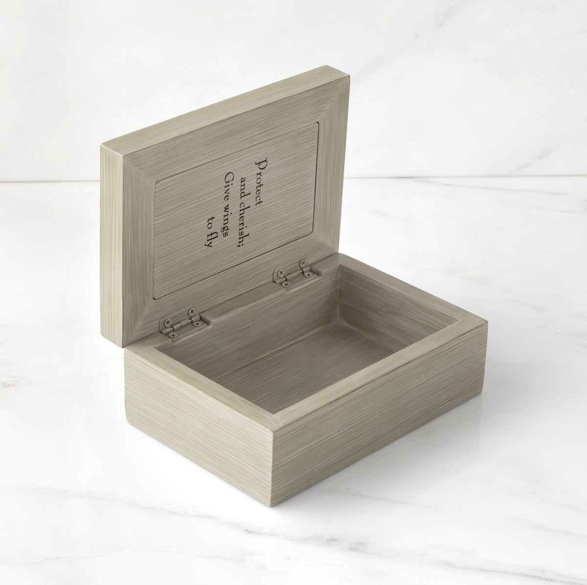 Light gray box open to show inside reads "Protect and cherish; give wings to fly"
