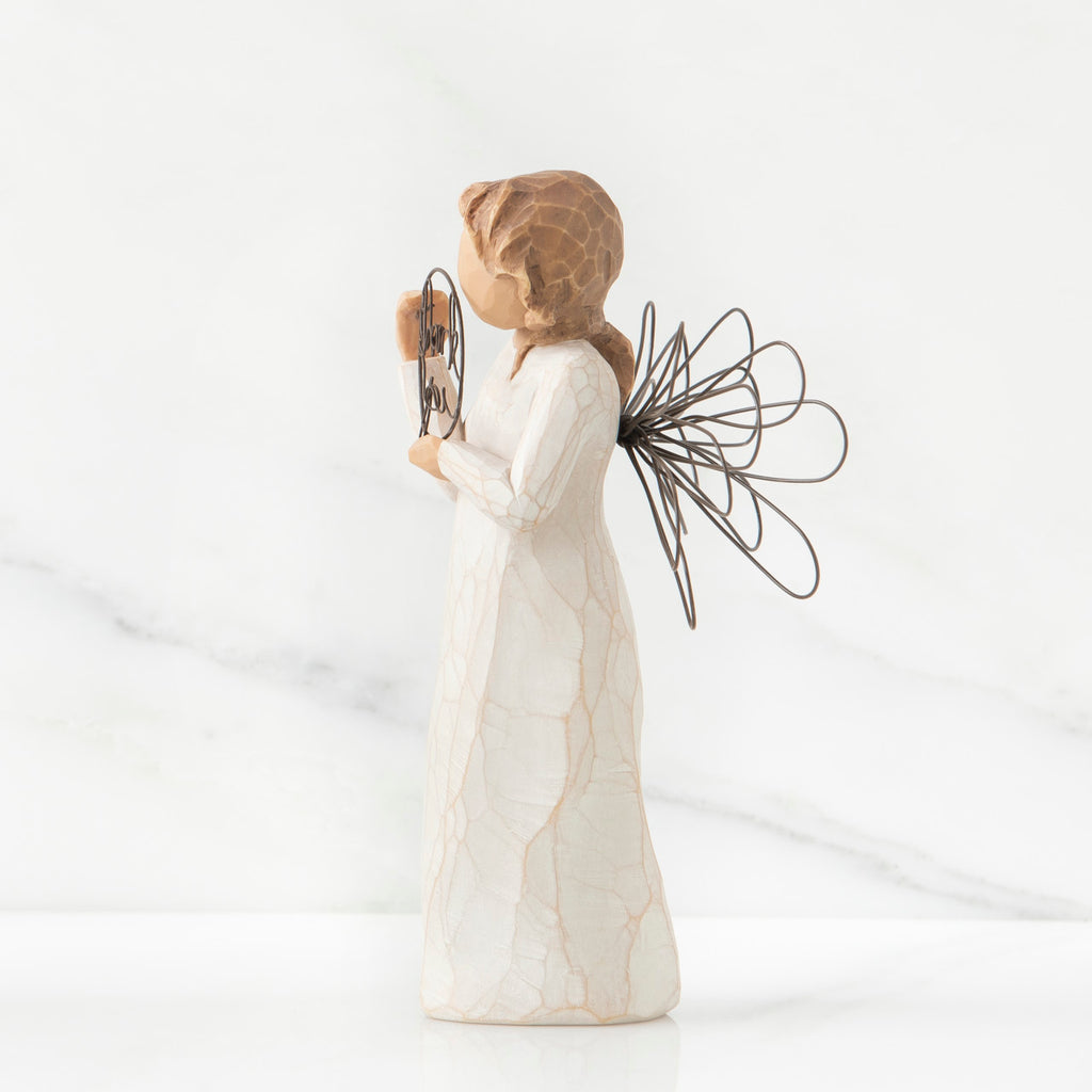 Right side view of angel with tied back brown hair, holding up a circular wire sign that says "thank you"