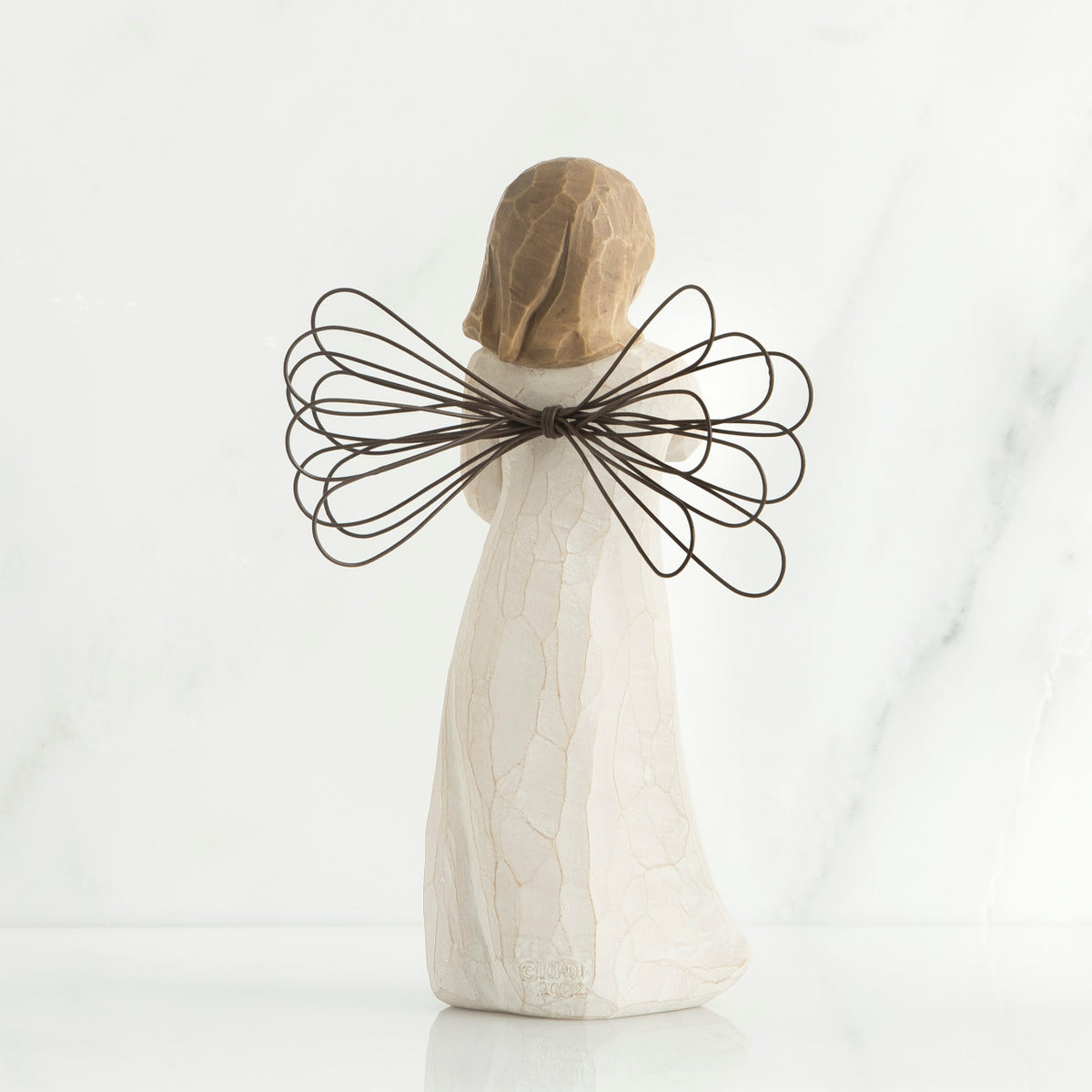 Back view of brunette girl figurine with brown wire wings standing up