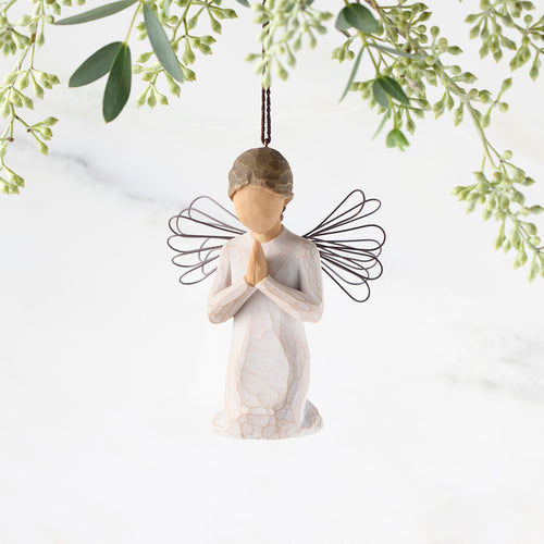 Figure of female angel in cream dress and wire wings, kneeling in prayer position, ornament loop on head