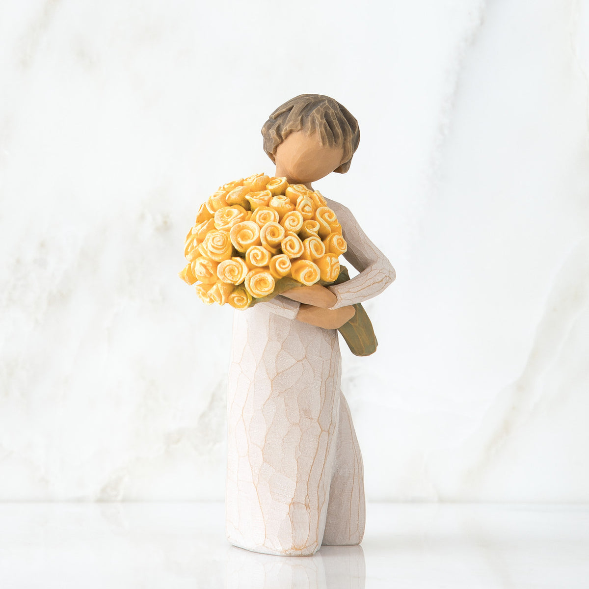 Front view of little girl with short brown hair holding a large bouquet of yellow roses