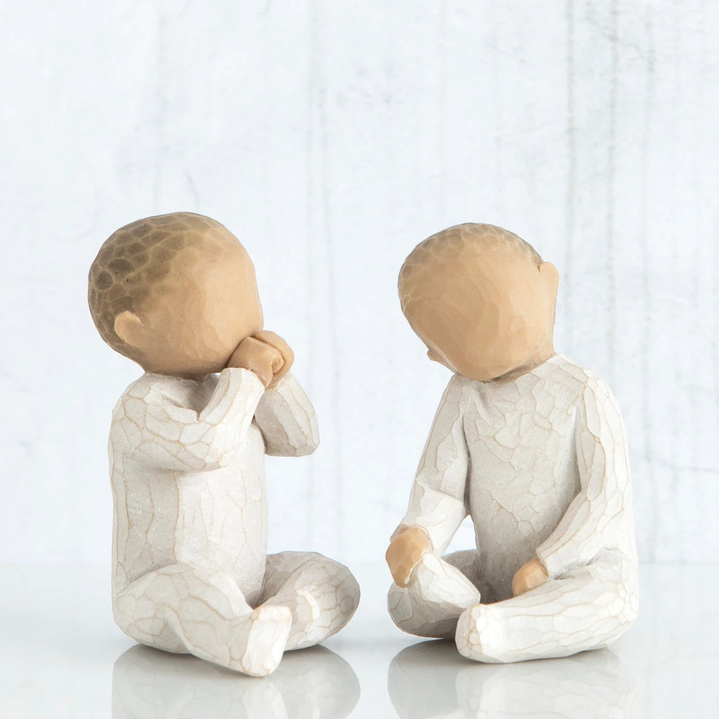 Set of two faceless little children figurines - sitting down, wearing all white