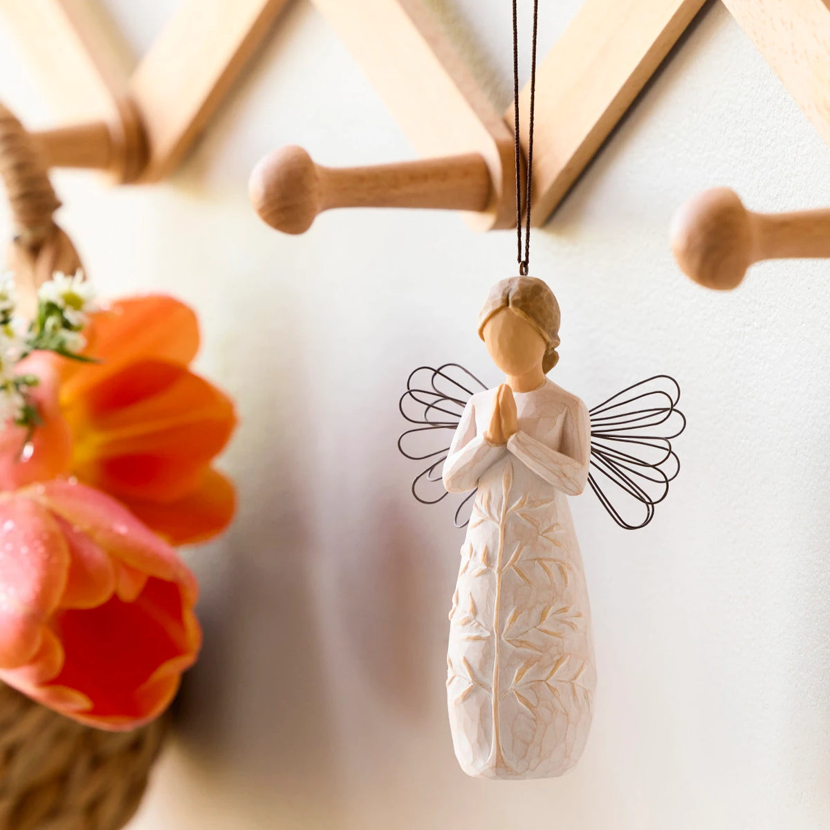 Willow Tree a tree, a prayer Ornament, 4”h hand-painted resin angel figure in cream dress with wire wings, hands in prayer position, tree carving on dress, brown elastic cord, hanging on decorative rack