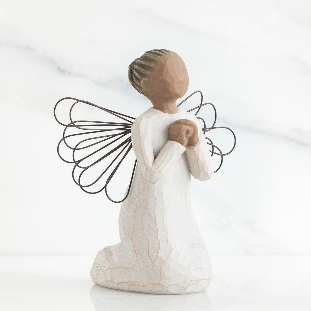 Faceless young girl figurine kneeling praying in white dress - she has black wire wings