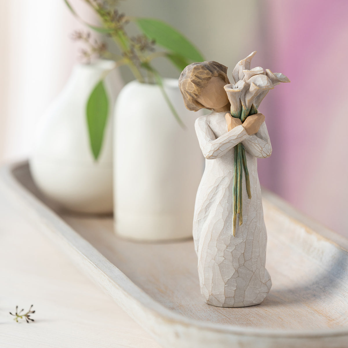 Willow Tree Beautiful Wishes, 5.5”h hand-painted standing resin figure in cream dress, holding bouquet of white calla lilies, on tray with florals