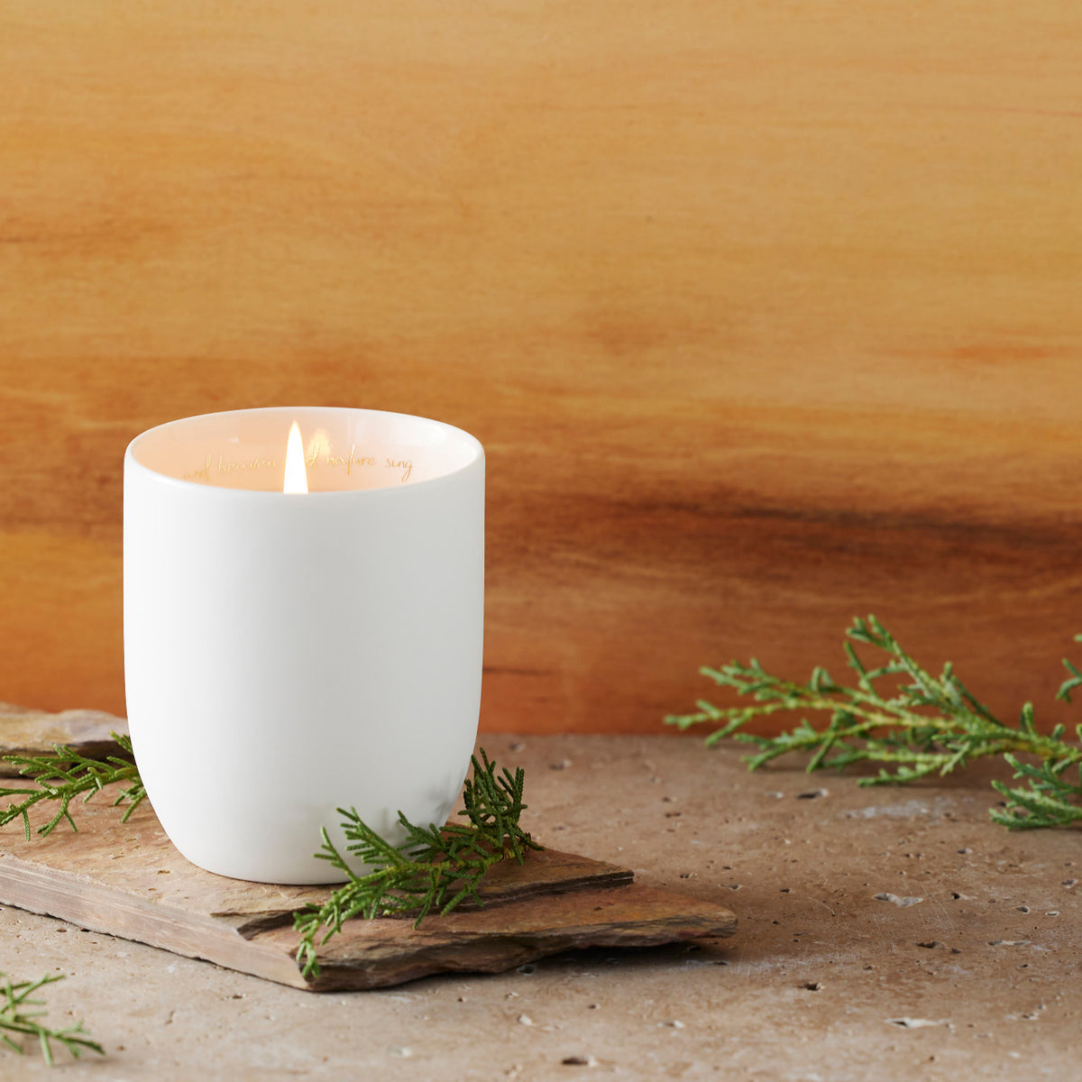 Filled scented candle with unglazed off-white tapered cylinder vessel, sentiment written in gold inside rim, plant-based wax blend, all-cotton wick.