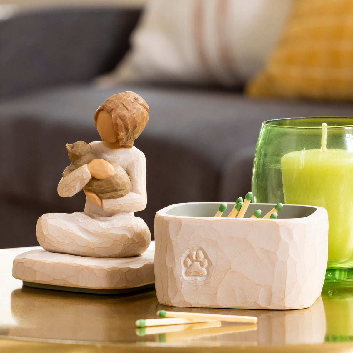 Willow Tree Kindness (girl) Keepsake Box, 3"sq hand-painted cream resin box with 3”H figure of seated girl holding cat affixed to lid, on table with candle, matches in box