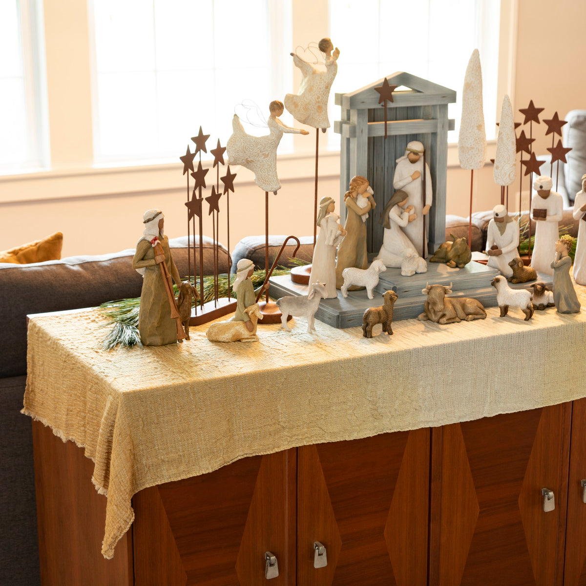 Display of Nativity Creche and figures atop gradated mustard color table runner, 2 ft by 5 ft gauze fabric, shown on top of sofa table